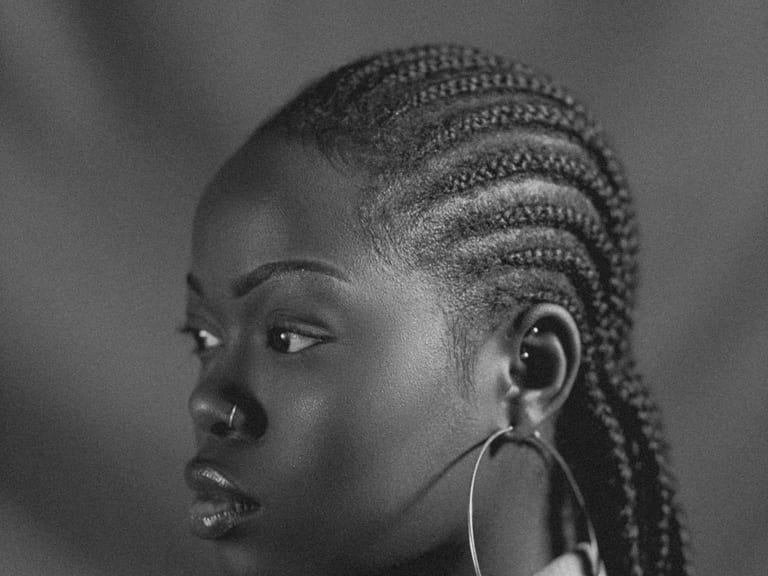 A client in profile with cornrows braided close to the scalp