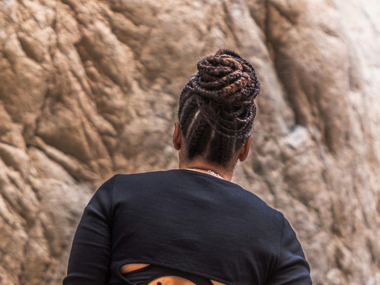 A braided updo seen from behind in warm light